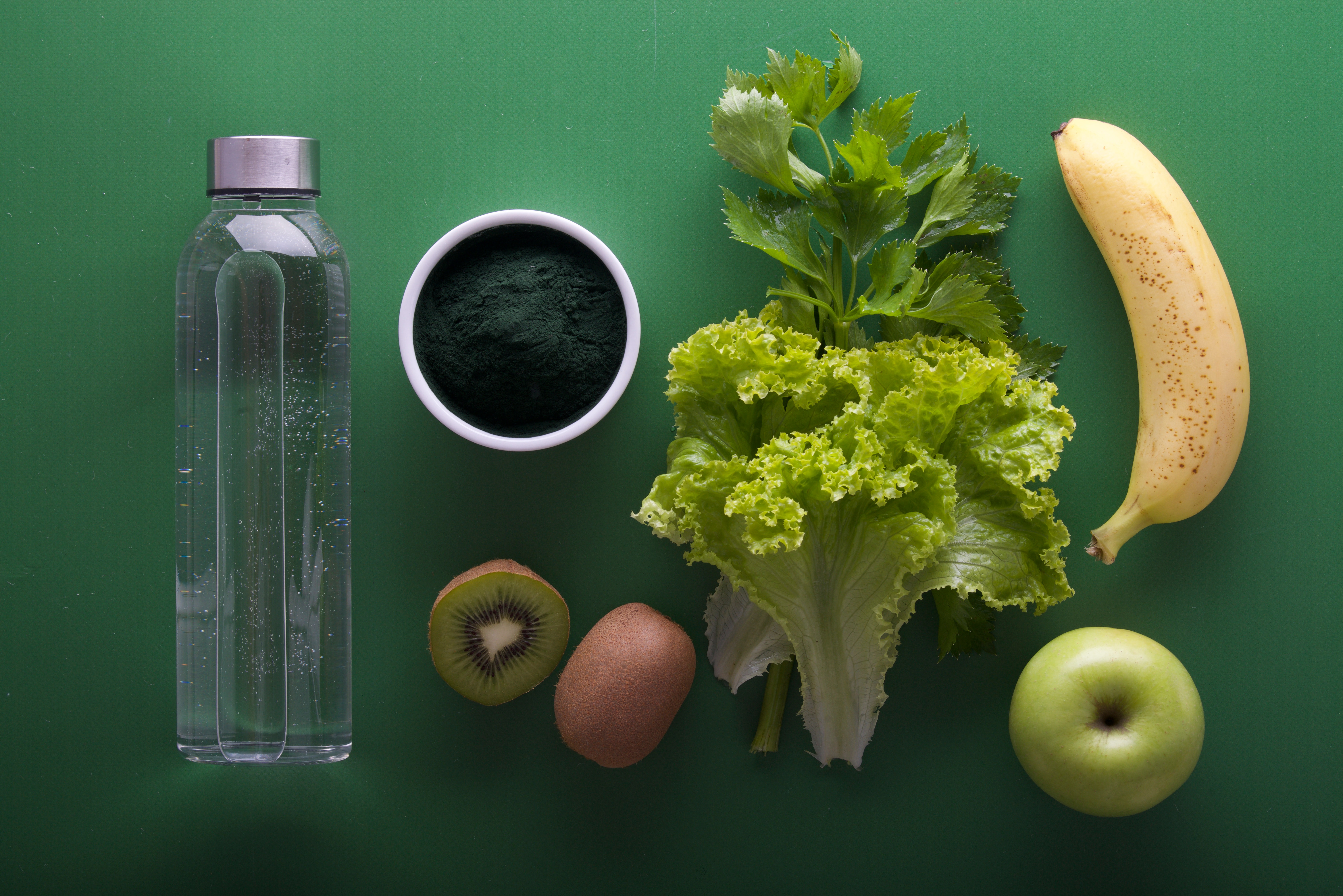 Bottle of water and miscellaneous fruits and greens