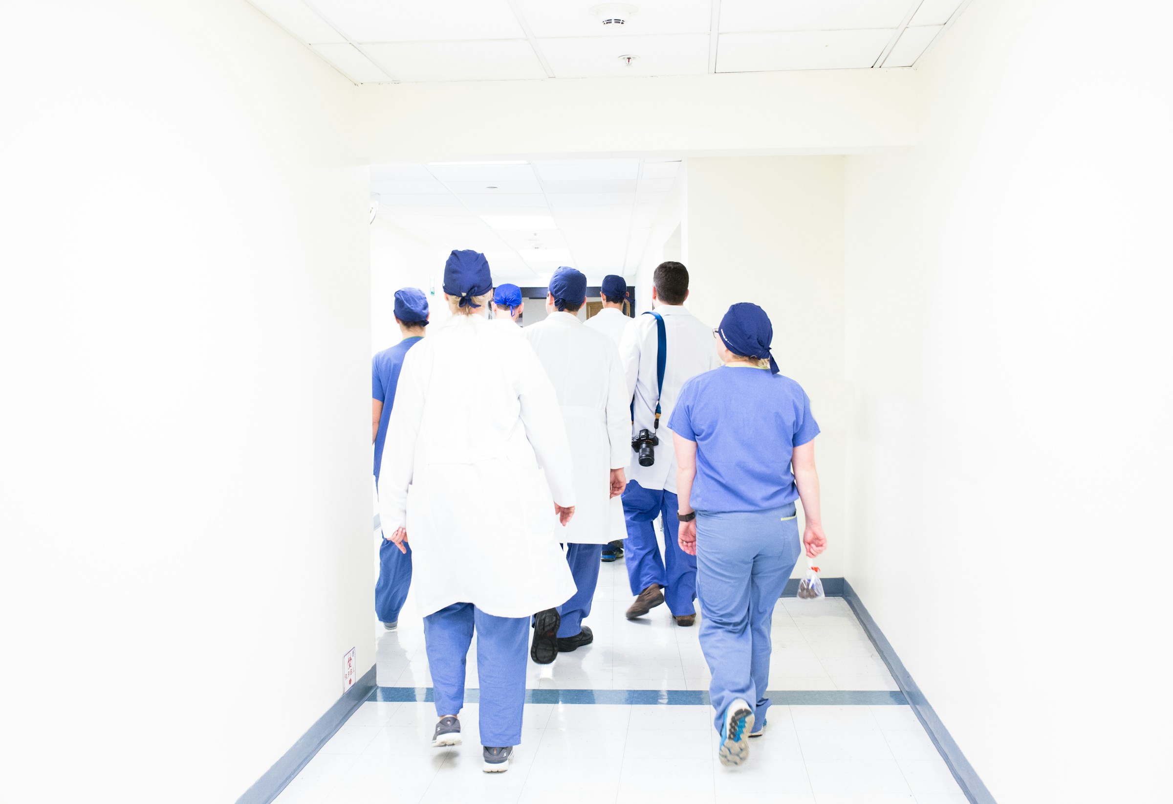 Group of medical professionals walking down a corridor